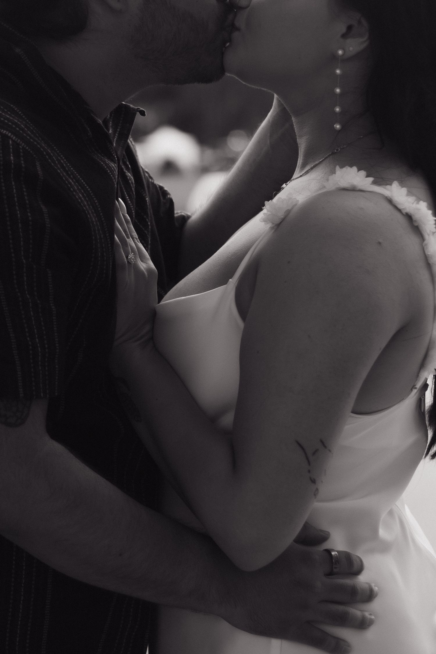 Black and white intimate portrait of a couple embracing.