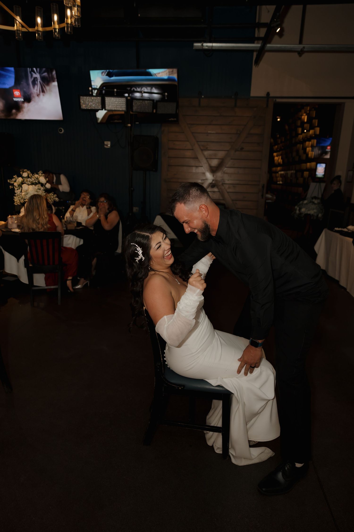 Bride and groom share a romantic dance moment at their indoor wedding reception venue.