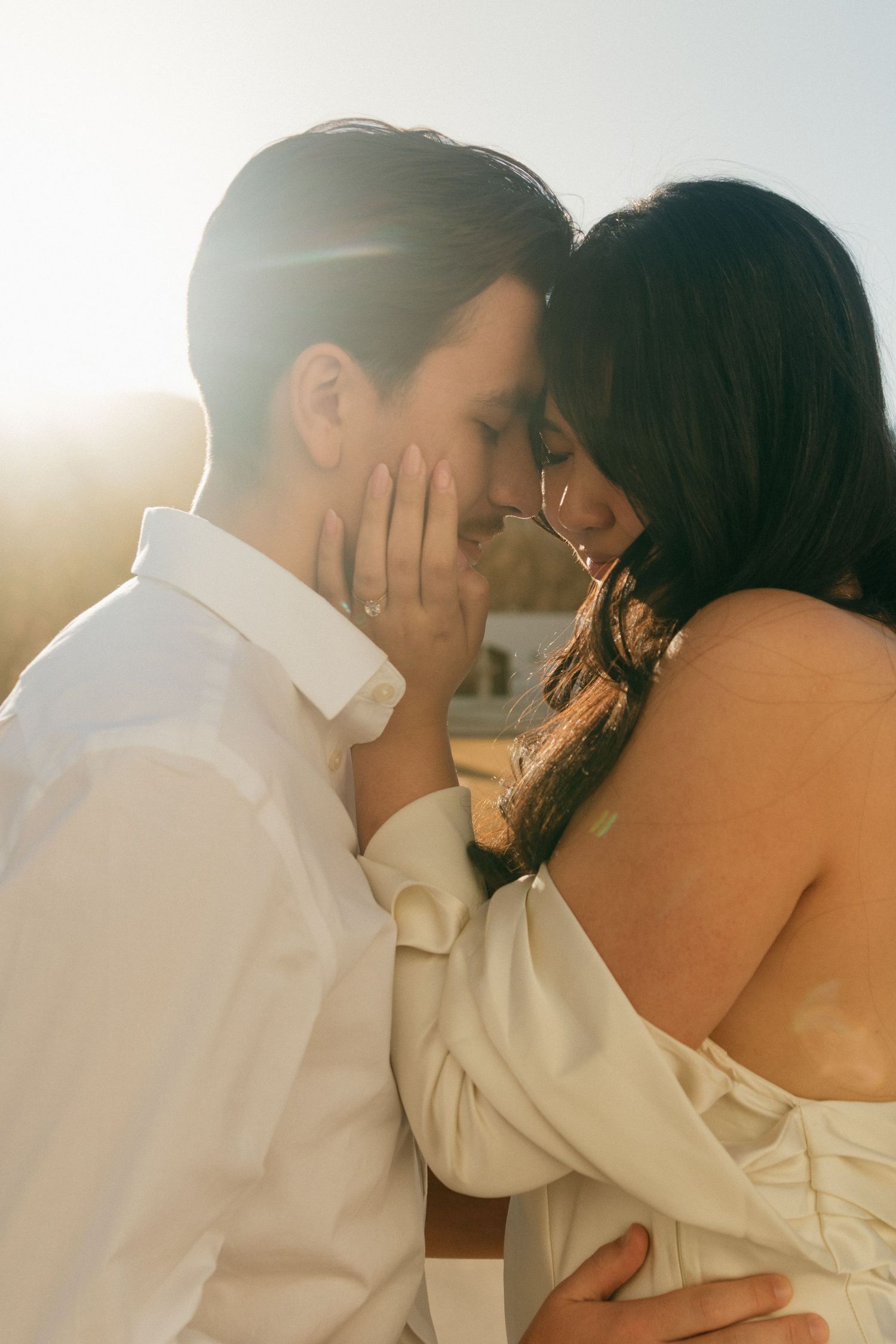 A tender embrace captured in golden sunlight with soft, romantic lighting.