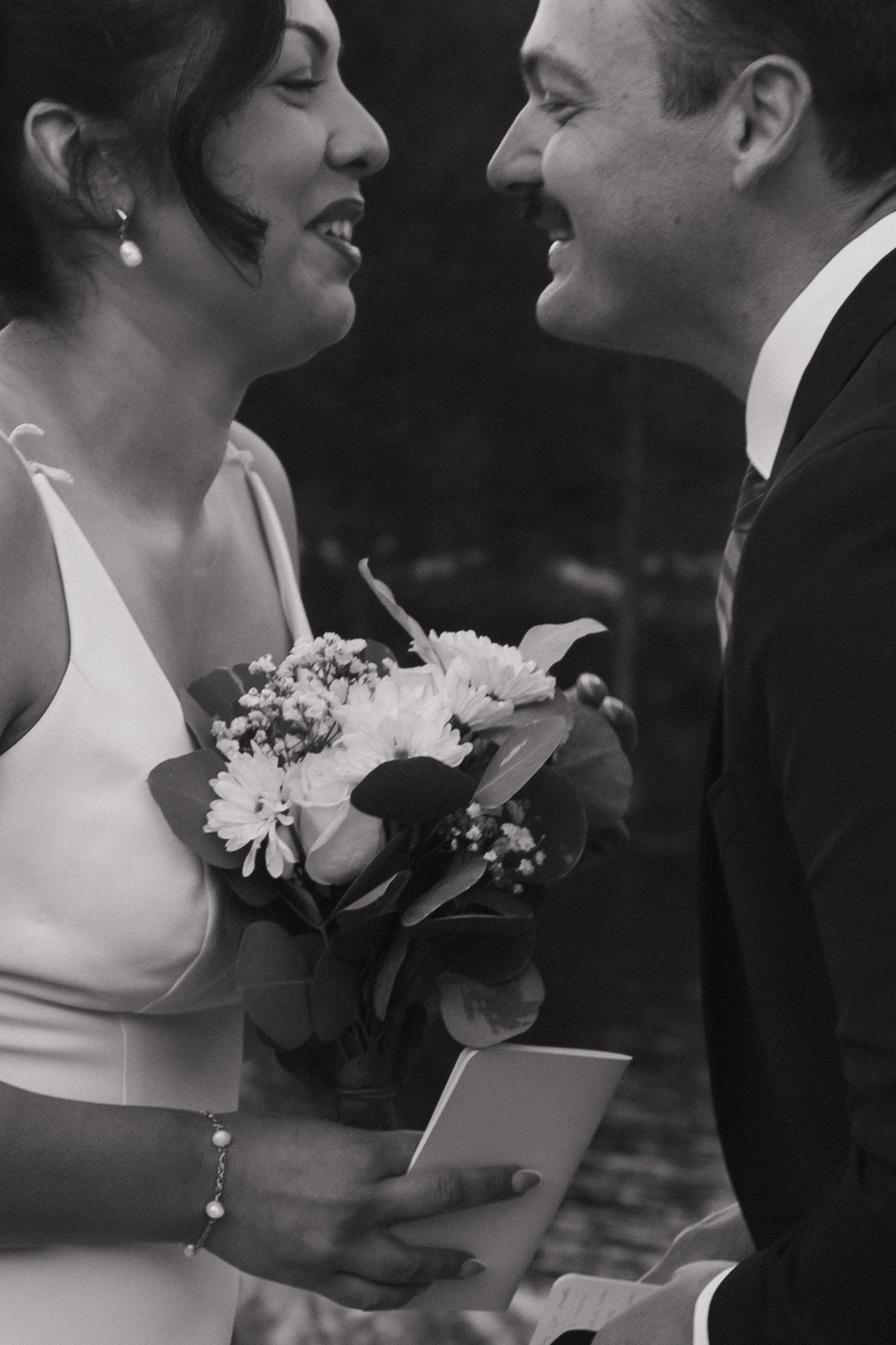 A black and white wedding photo sequence shows a romantic close-up moment between a couple with flowers.