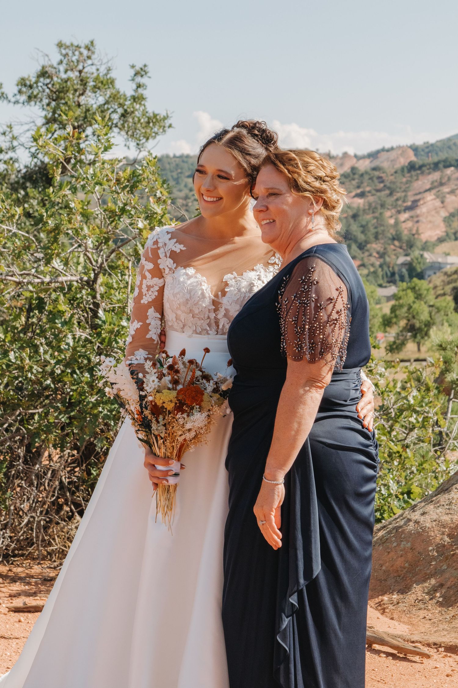 A beautiful wedding moment captured against a backdrop of rolling hills and mountain scenery.