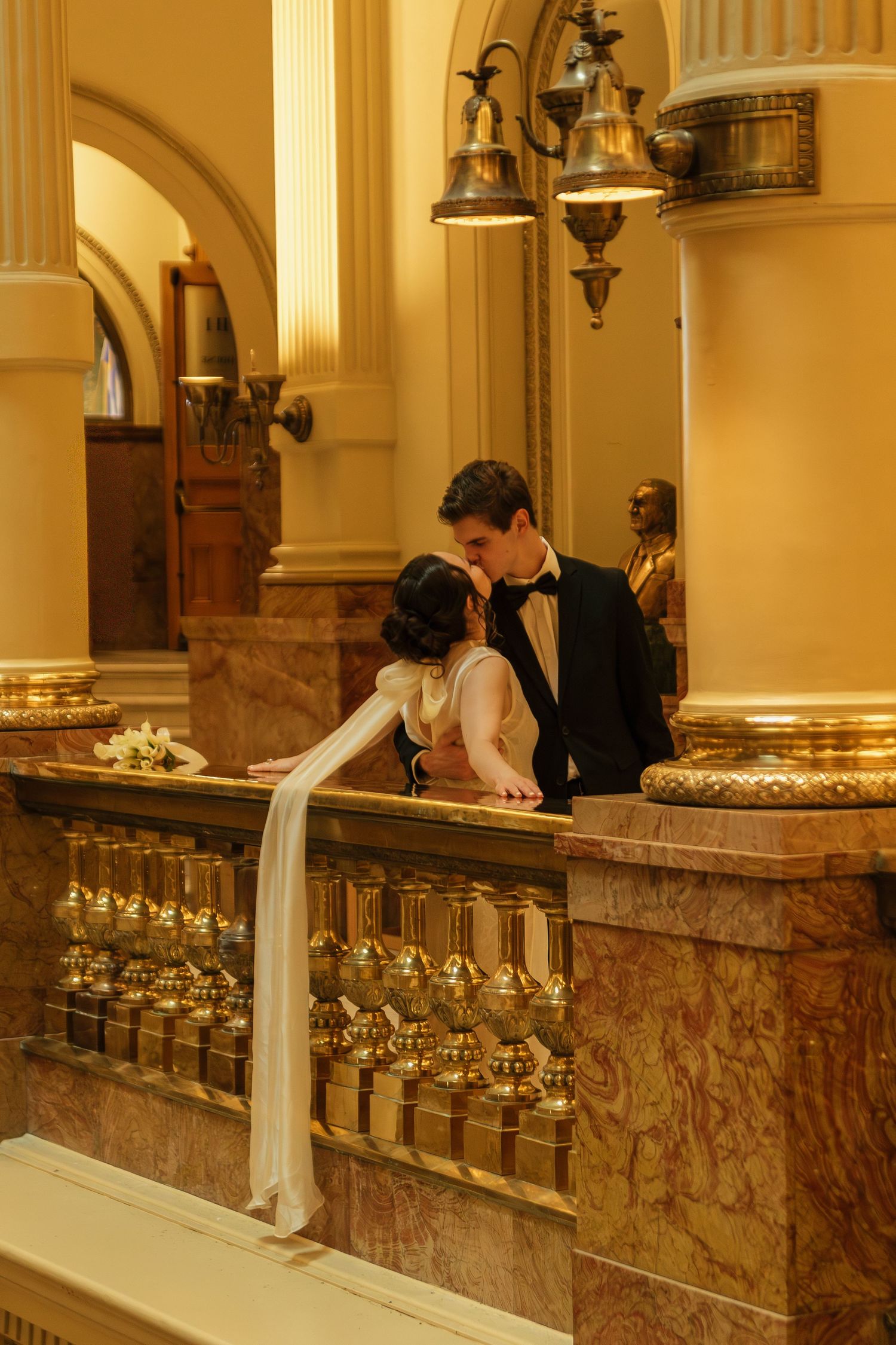 Elegant marble bar counter in a luxurious hotel or restaurant with classic architectural columns and warm lighting.
