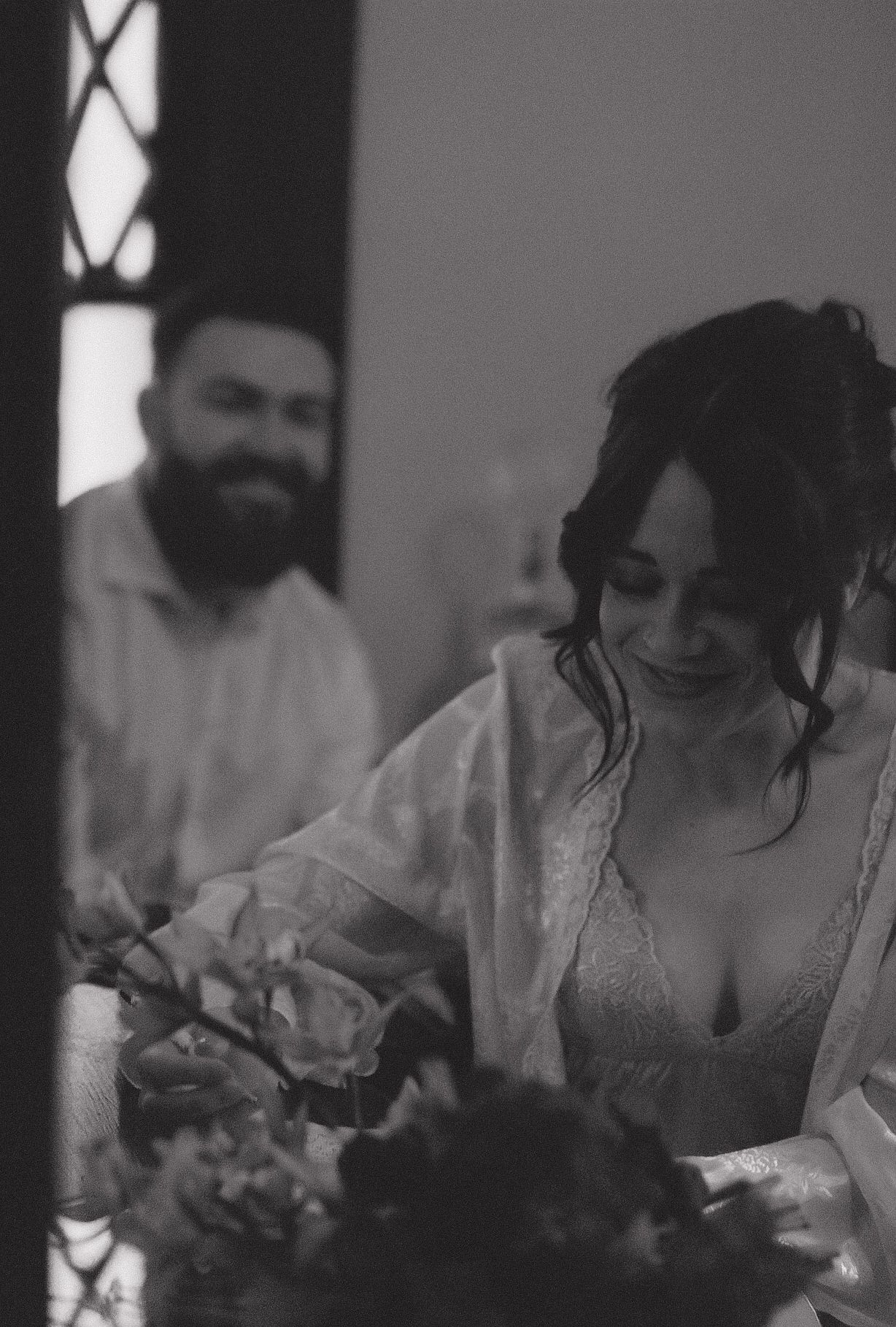 A candid black and white photo of wedding day preparations.