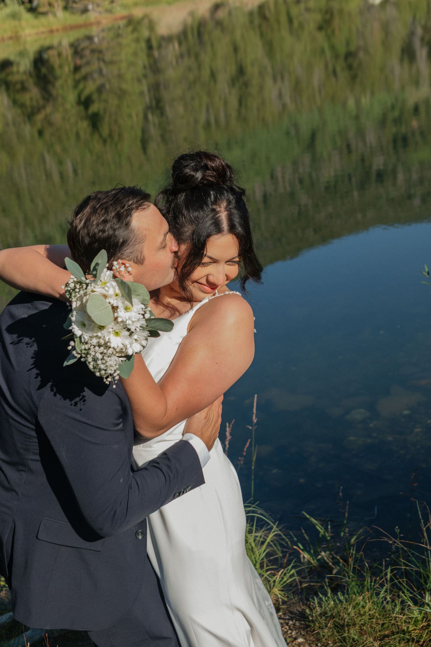 Intimate wedding moments captured against a tranquil lake backdrop.