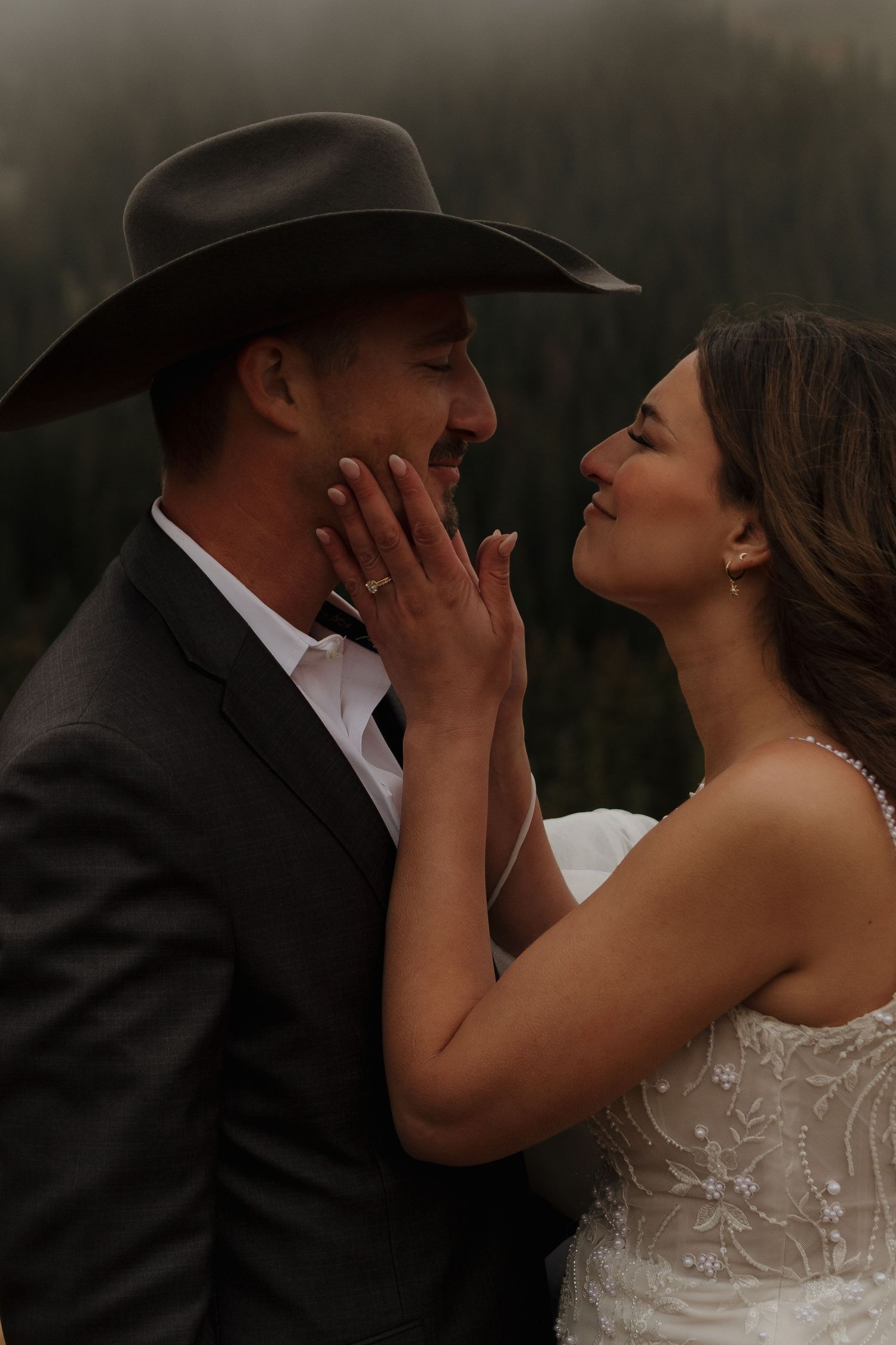 An intimate moment between newlyweds against a mountain backdrop.