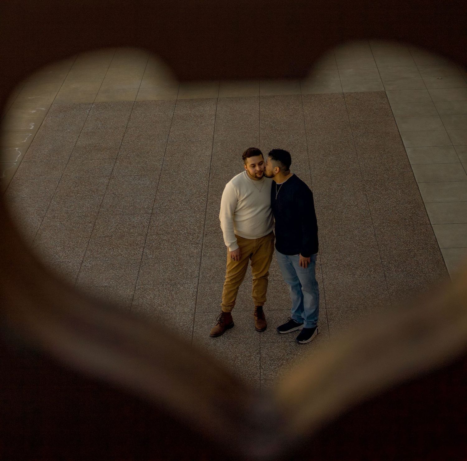 Two figures move together in dim lighting across a concrete surface, shown in sequential frames.