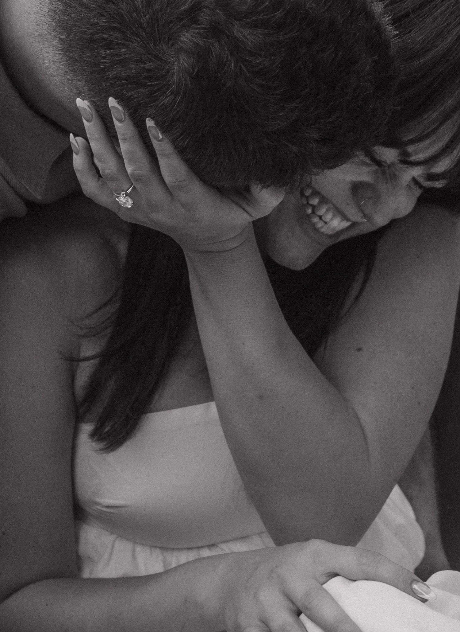 Black and white intimate portrait capturing tender moments between a couple.