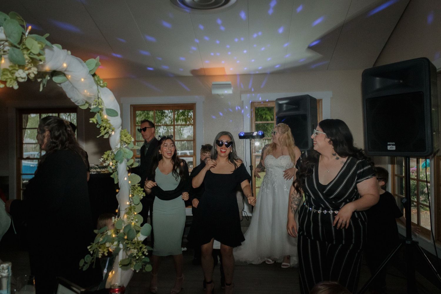 Dance floor scene with blue disco lights creating patterns across the ceiling.