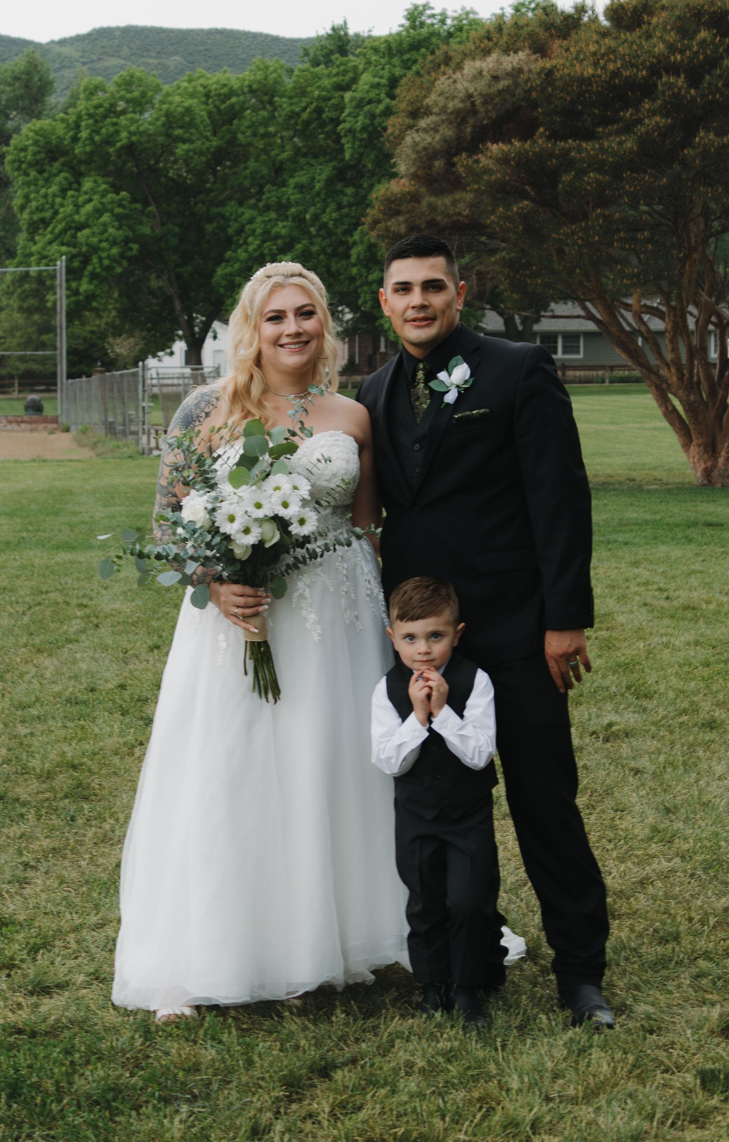 An outdoor wedding scene with mountains and trees creating a natural backdrop.