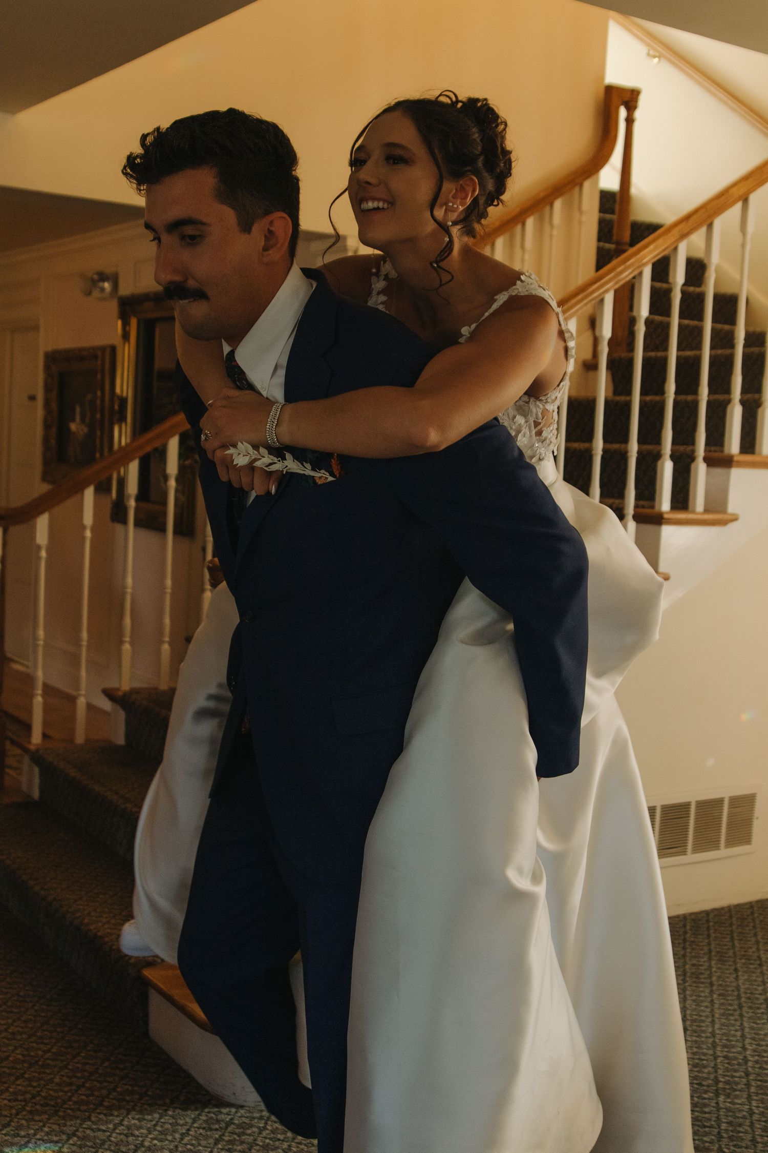 Candid moments of embracing during a wedding celebration indoors.