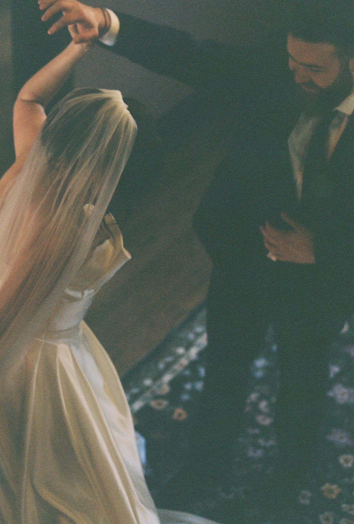 Soft-focus vintage style photo of a couple dancing at their wedding reception.