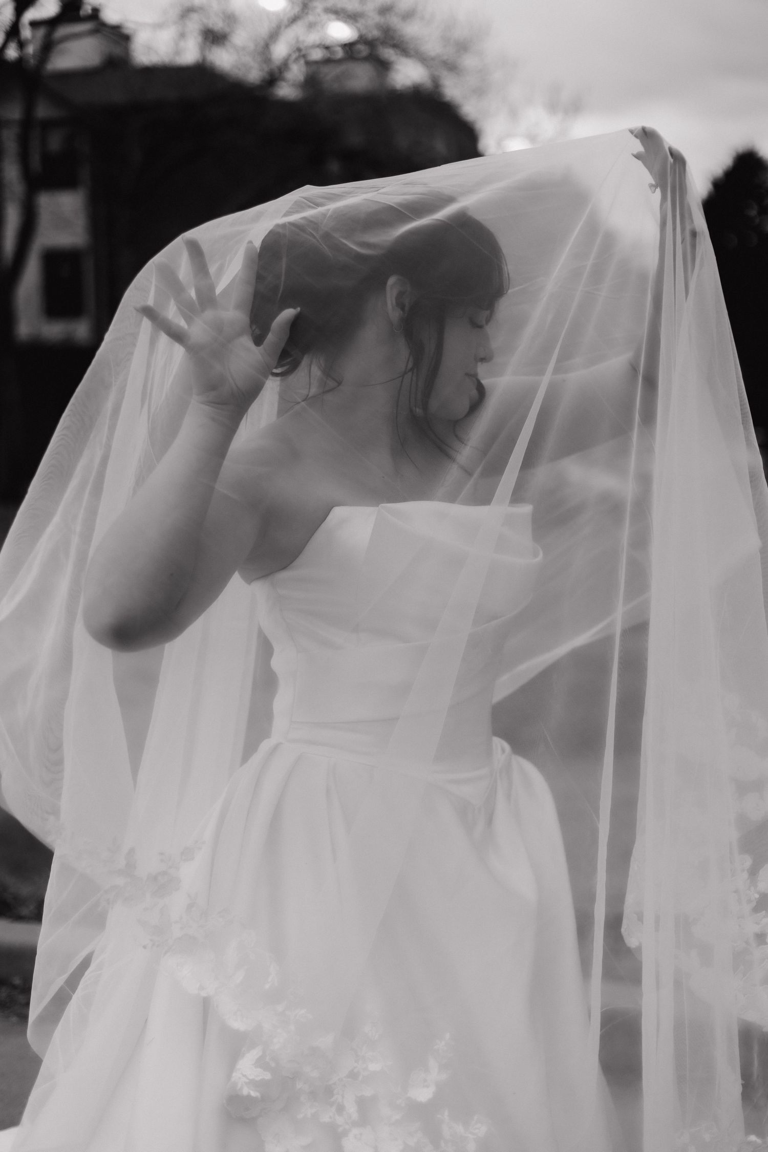 Series of black and white images showing flowing white wedding veil details.