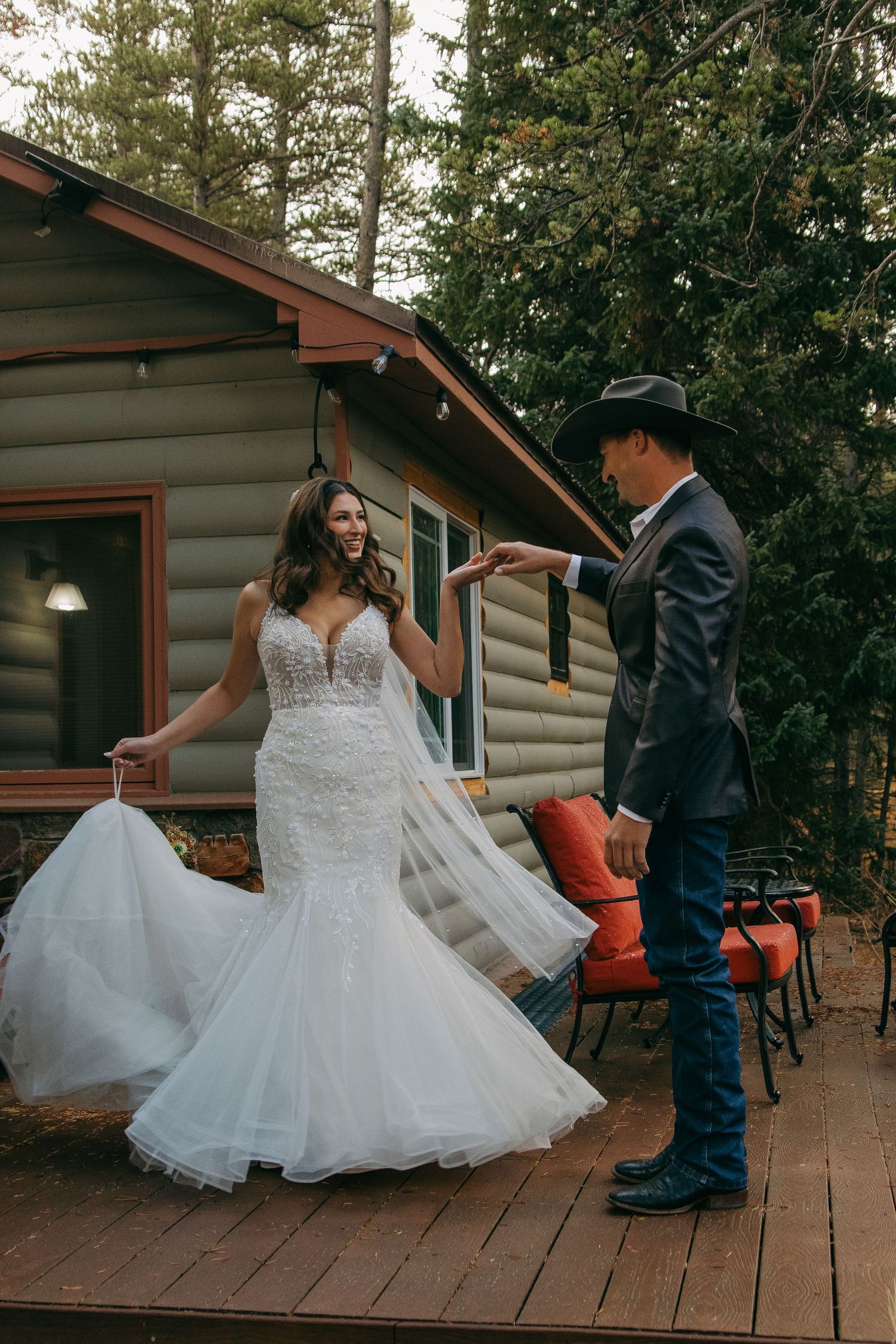 Dancing on a rustic cabin deck surrounded by pine trees.