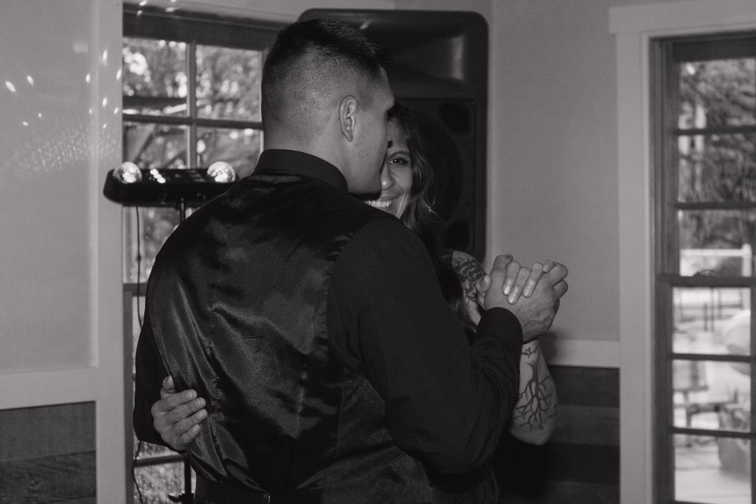 Black and white photo of a couple sharing an intimate dance moment at their wedding reception.