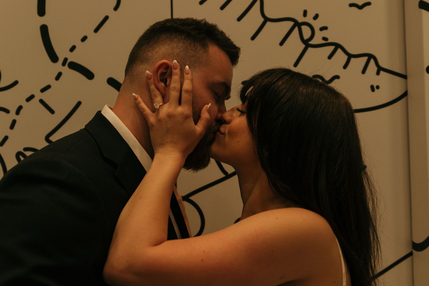 A romantic dance sequence captured in warm tones against an artistic backdrop.