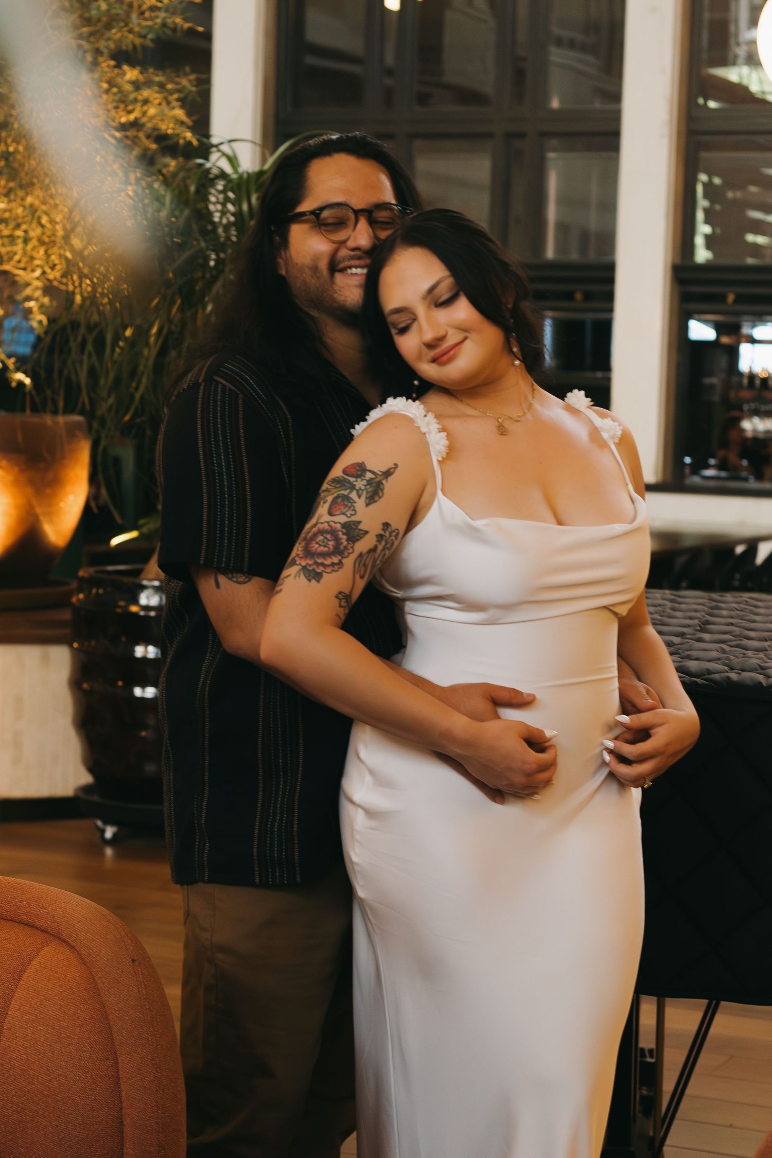 A tender moment captured in an elegantly decorated indoor setting with warm lighting.