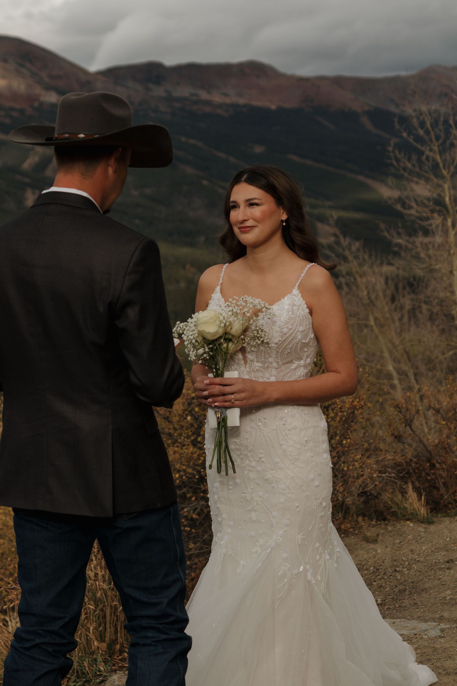 A mountain wedding ceremony with scenic fall foliage in the background.