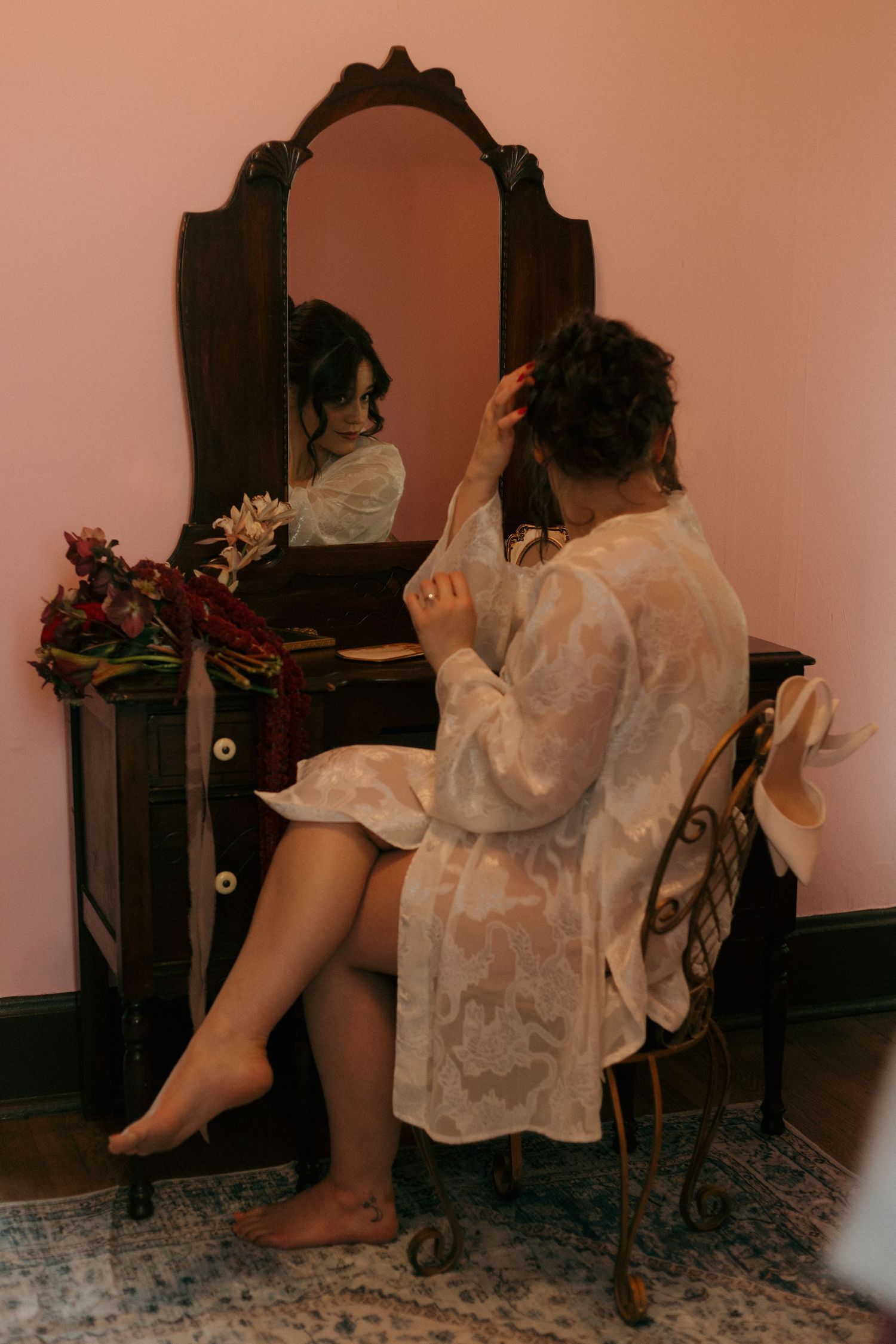 Vintage-style boudoir photo with antique mirror and romantic lighting.