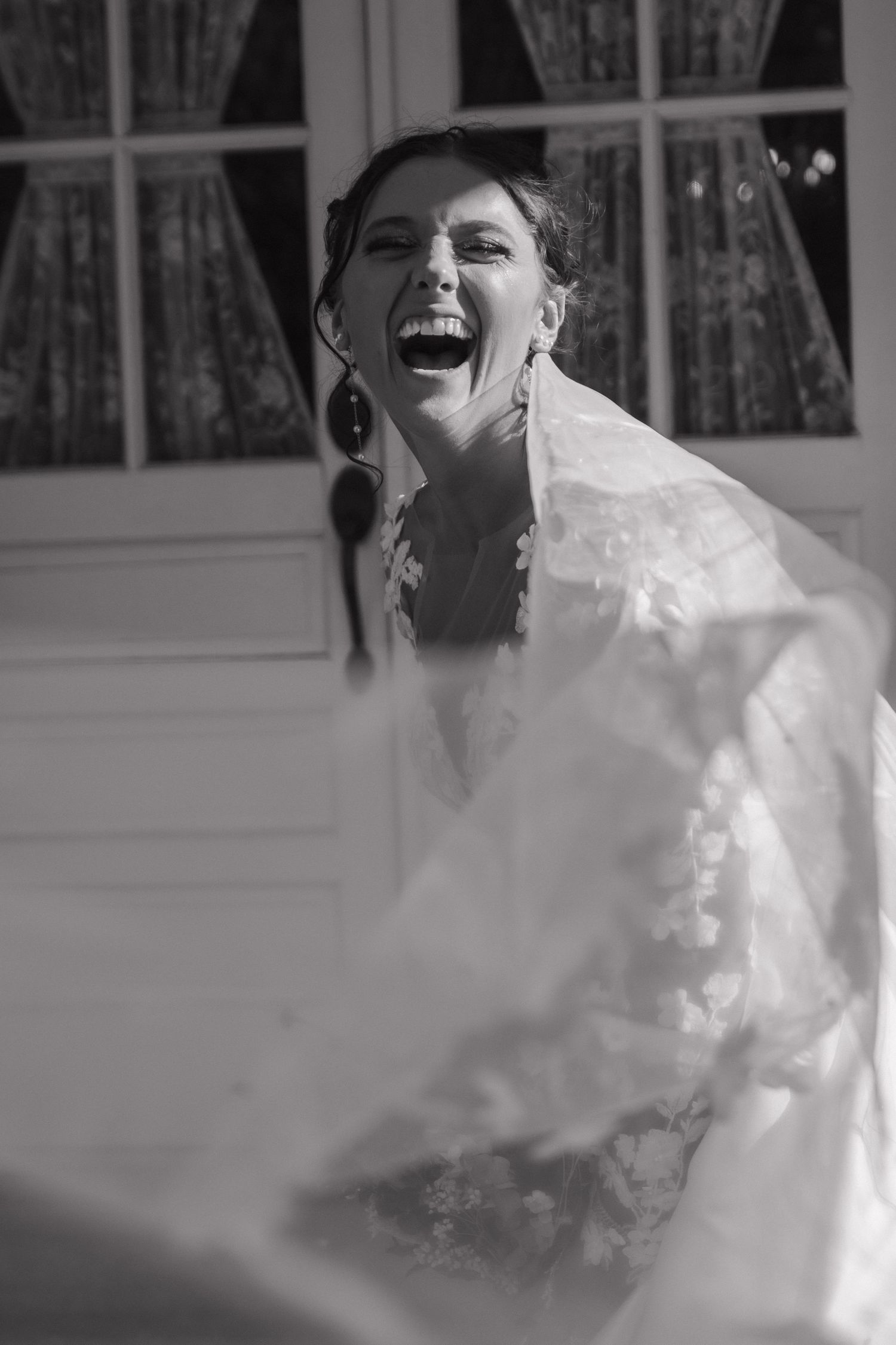 A candid black and white portrait capturing pure joy and laughter.