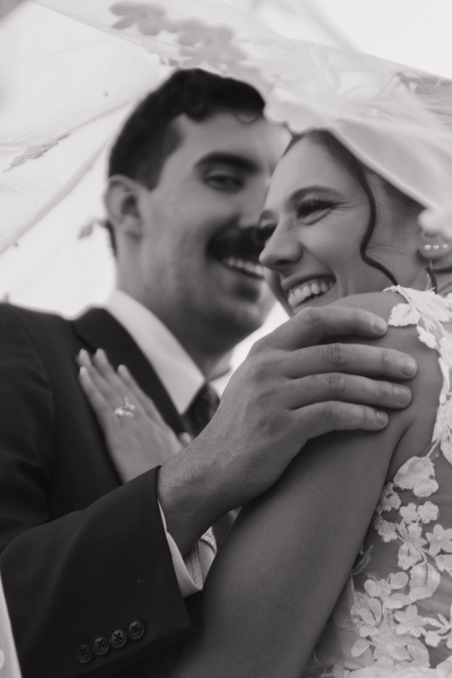 Black and white close-up shots of intimate wedding moments between newlyweds.