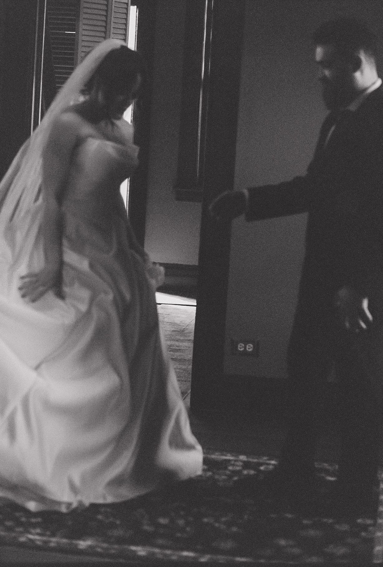 A dreamy black and white dance scene with flowing white dress movement.