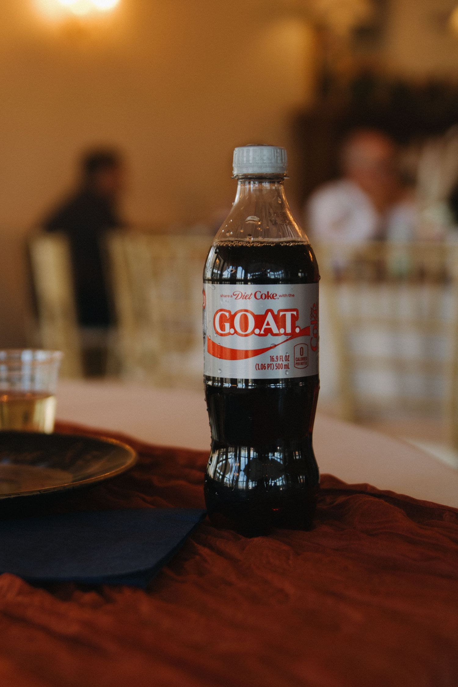 Glass Coca-Cola bottles arranged on a wooden table surface.