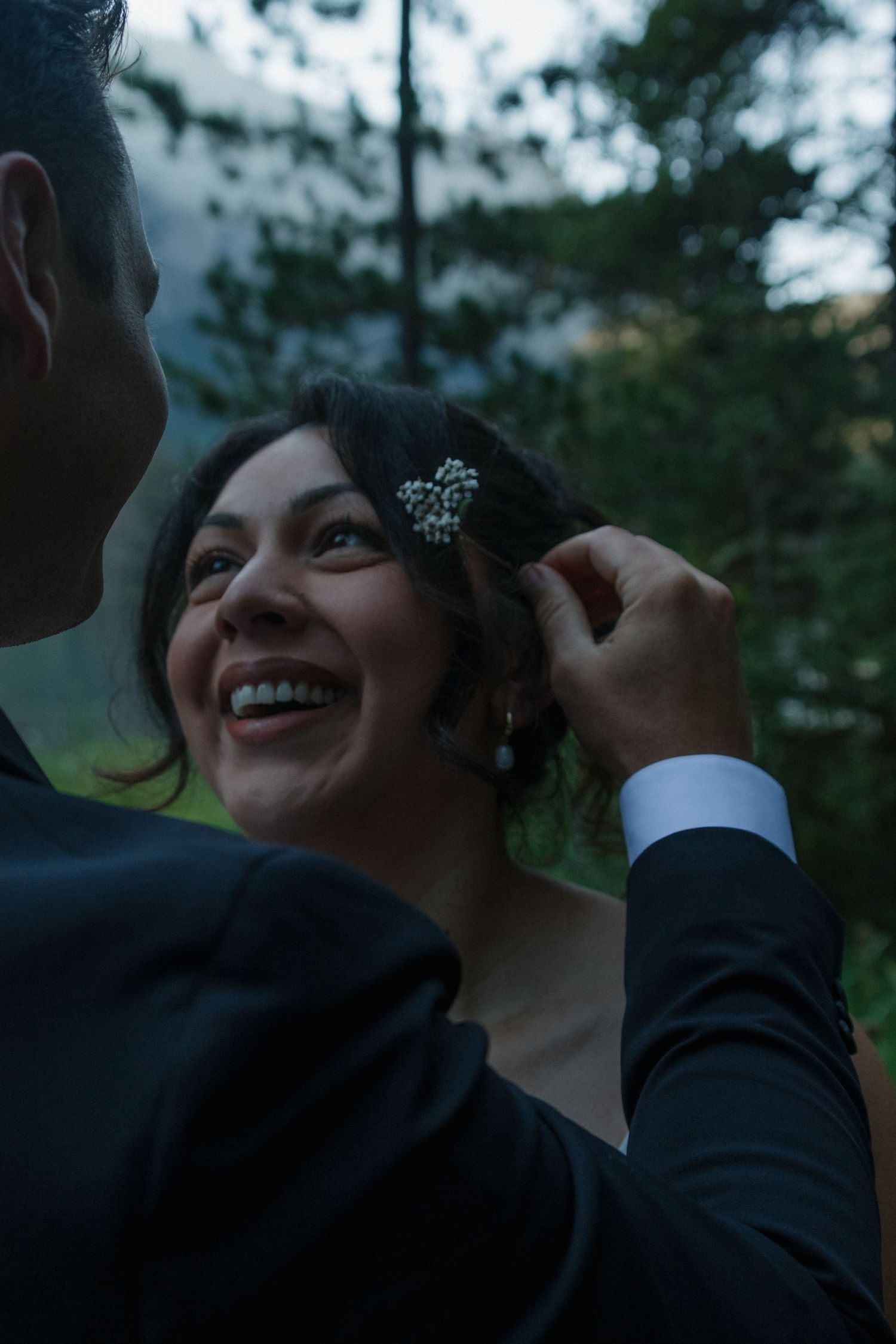 An intimate wedding moment captured during twilight in a mountain setting.