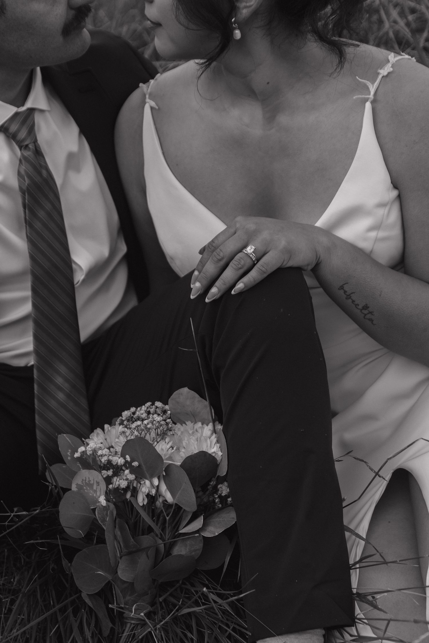 Black and white wedding photography showing intimate moments and floral details.