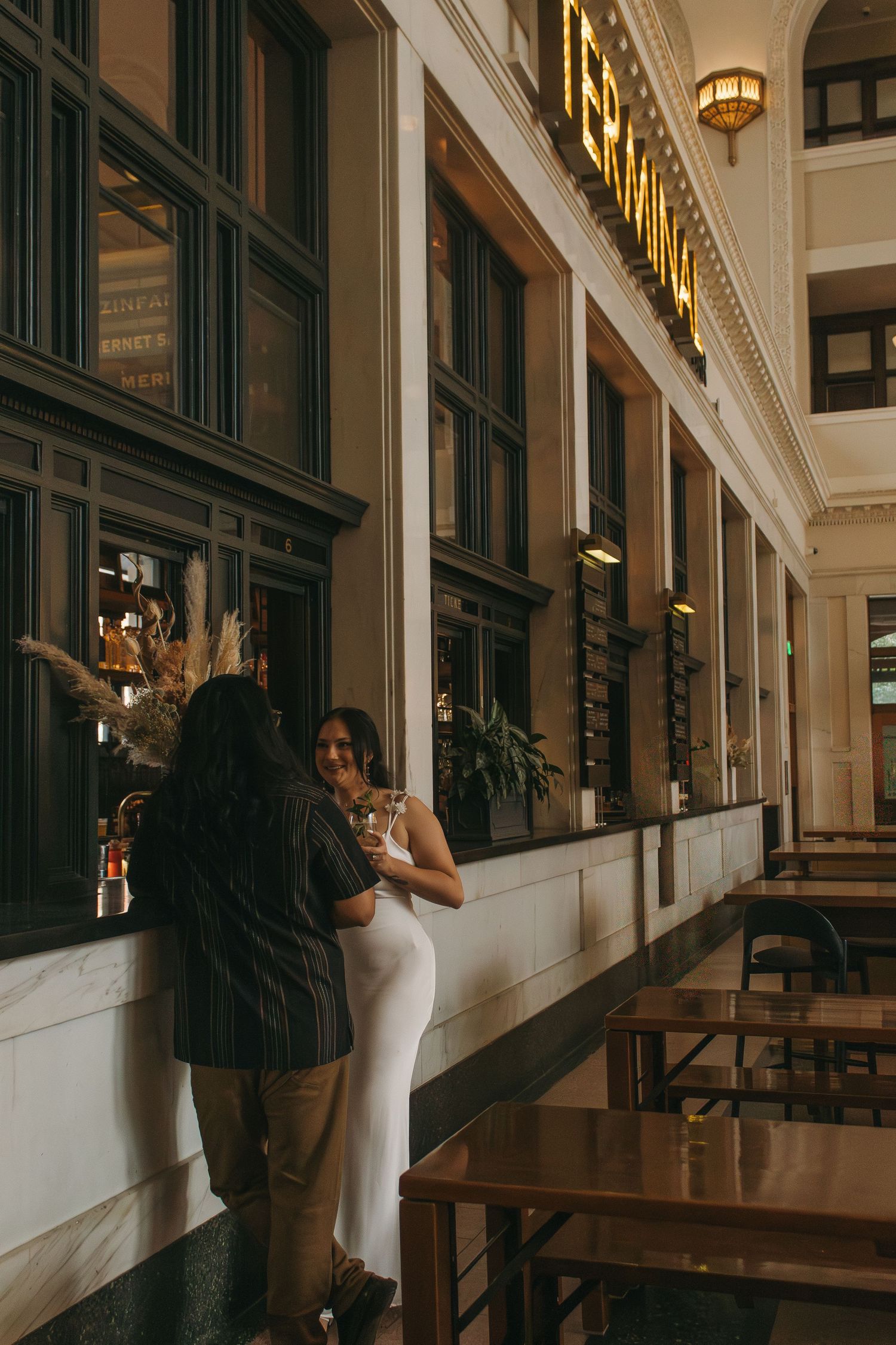 A romantic dance sequence inside an elegant building with ornate architecture and warm lighting.