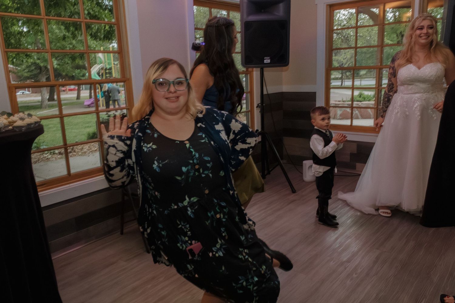 Reception venue with large windows and guests enjoying the celebration.