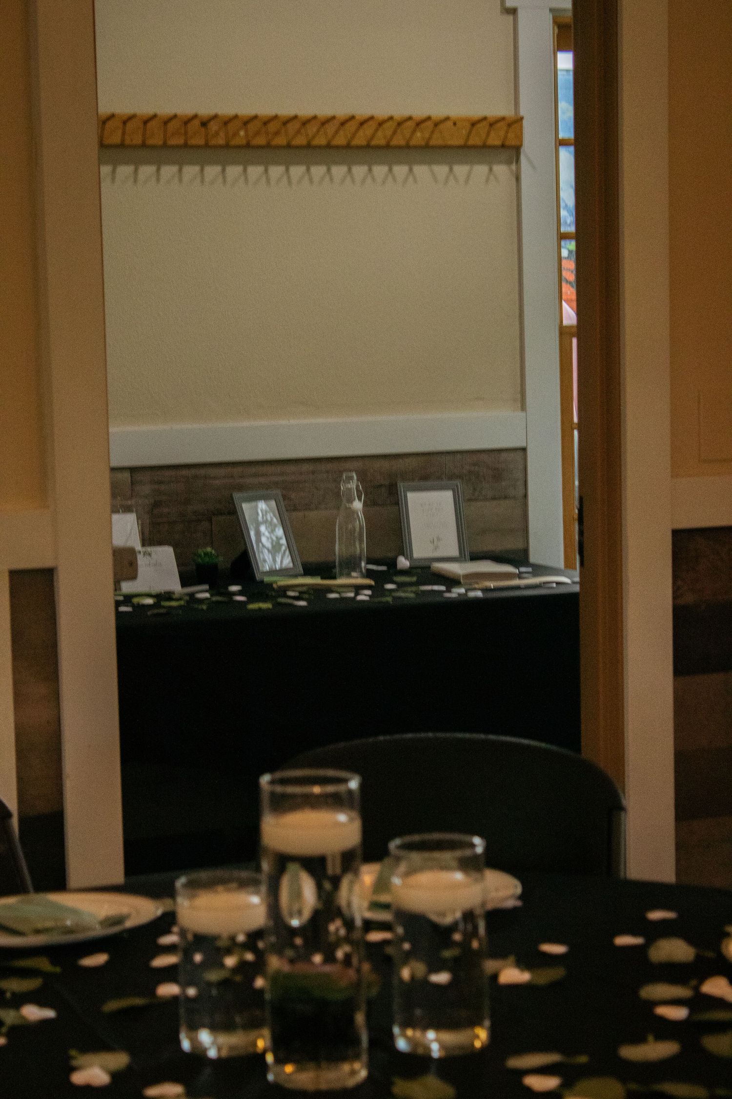 Wedding reception hall with tables set up and soft ambient lighting.