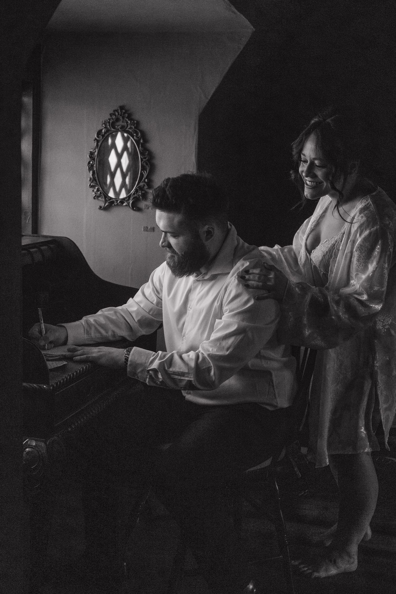 Black and white candid moments showing preparations in a dimly lit room.