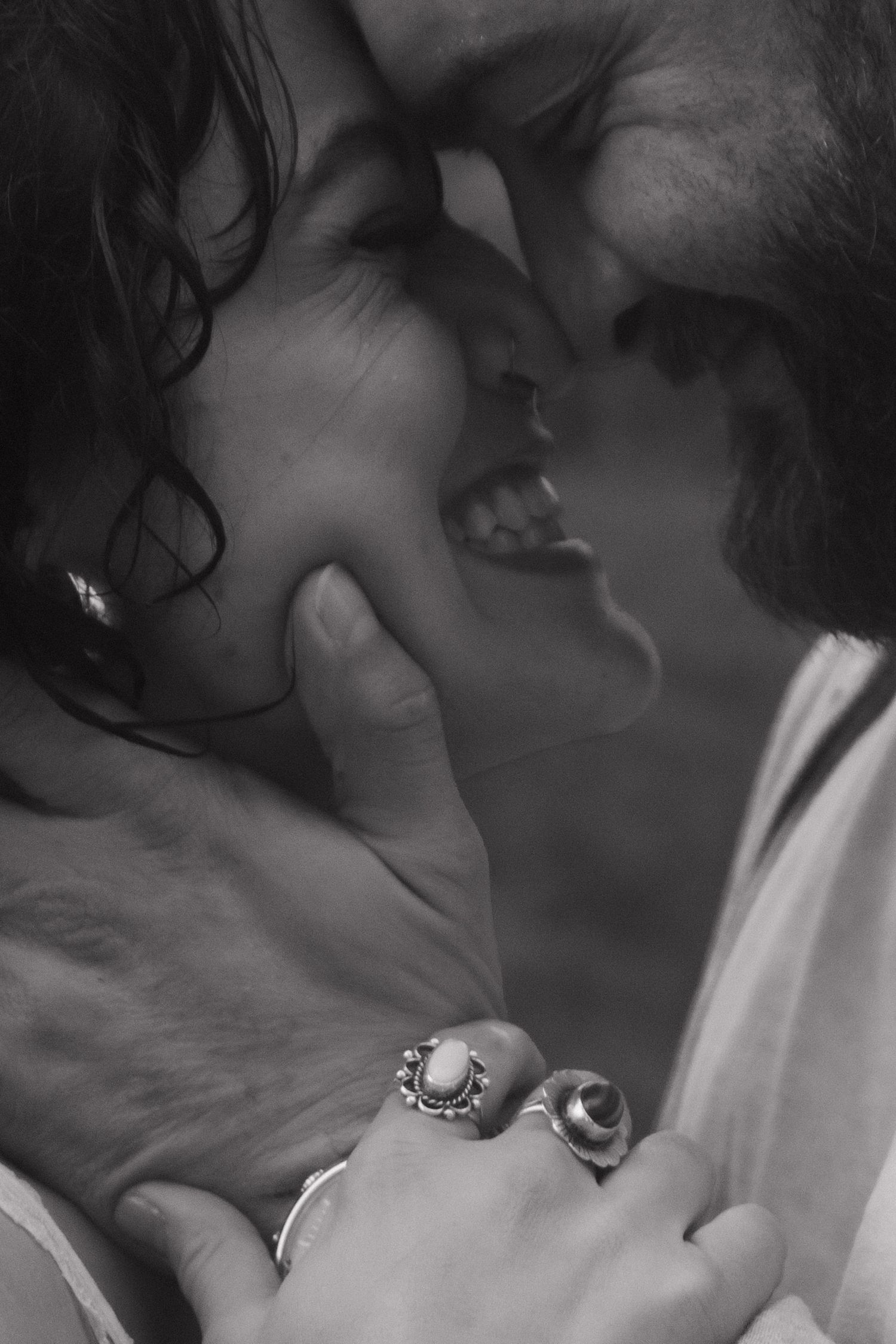 Close-up black and white photos capture intimate moments between a couple.