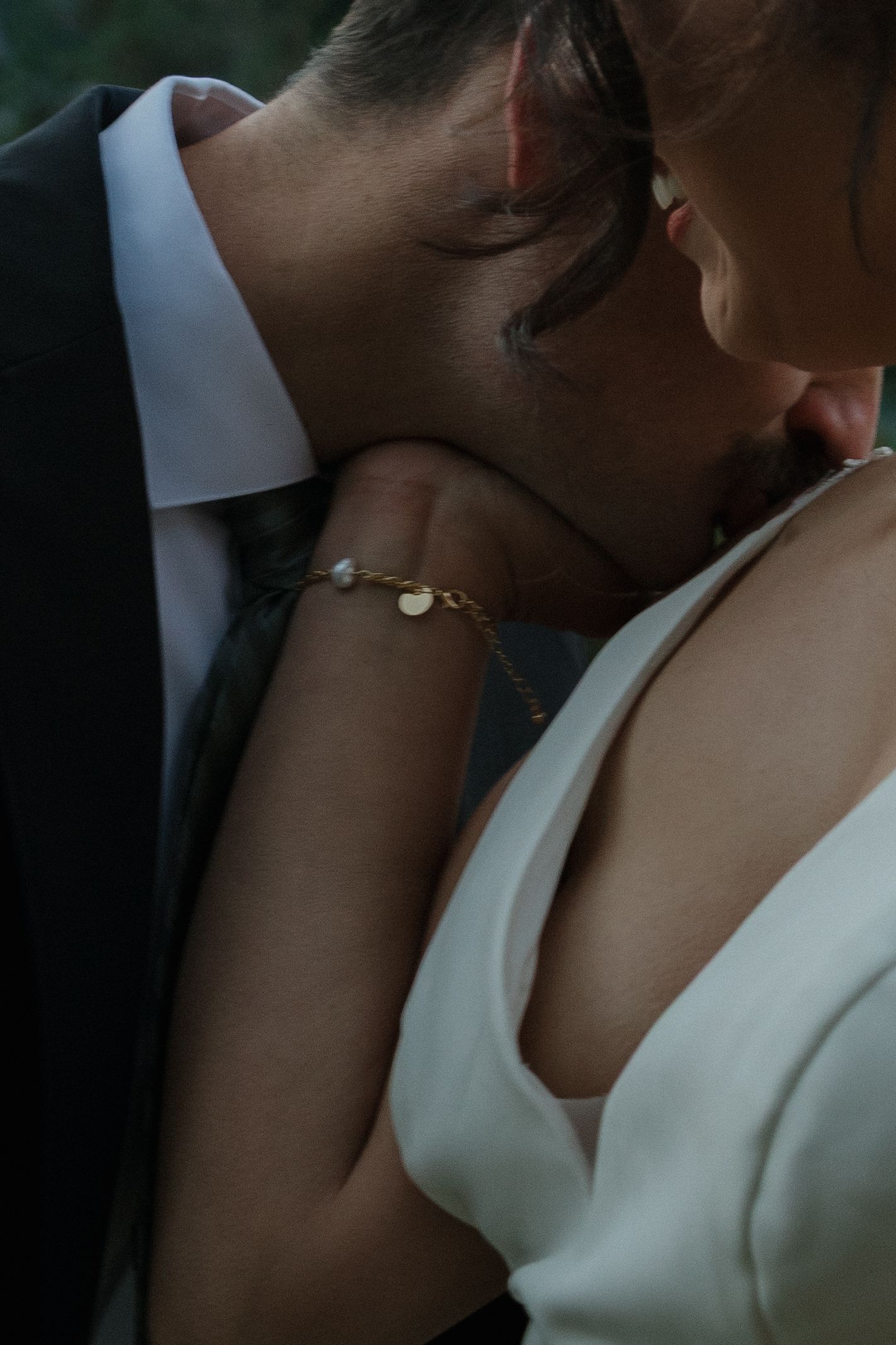 An intimate close-up moment between a couple in wedding attire.