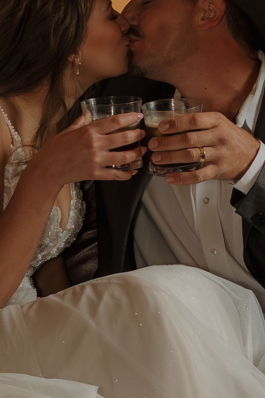 A romantic wedding toast with glasses clinking during an intimate moment.