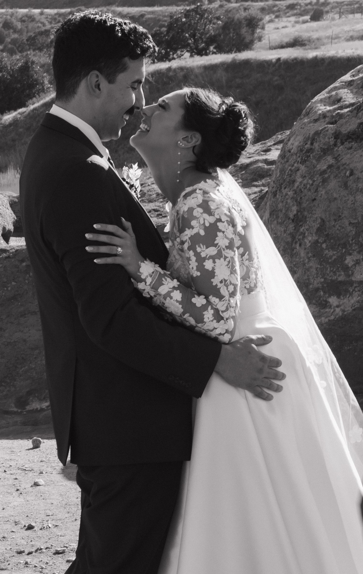 Romantic black and white wedding portraits against desert rock formations.