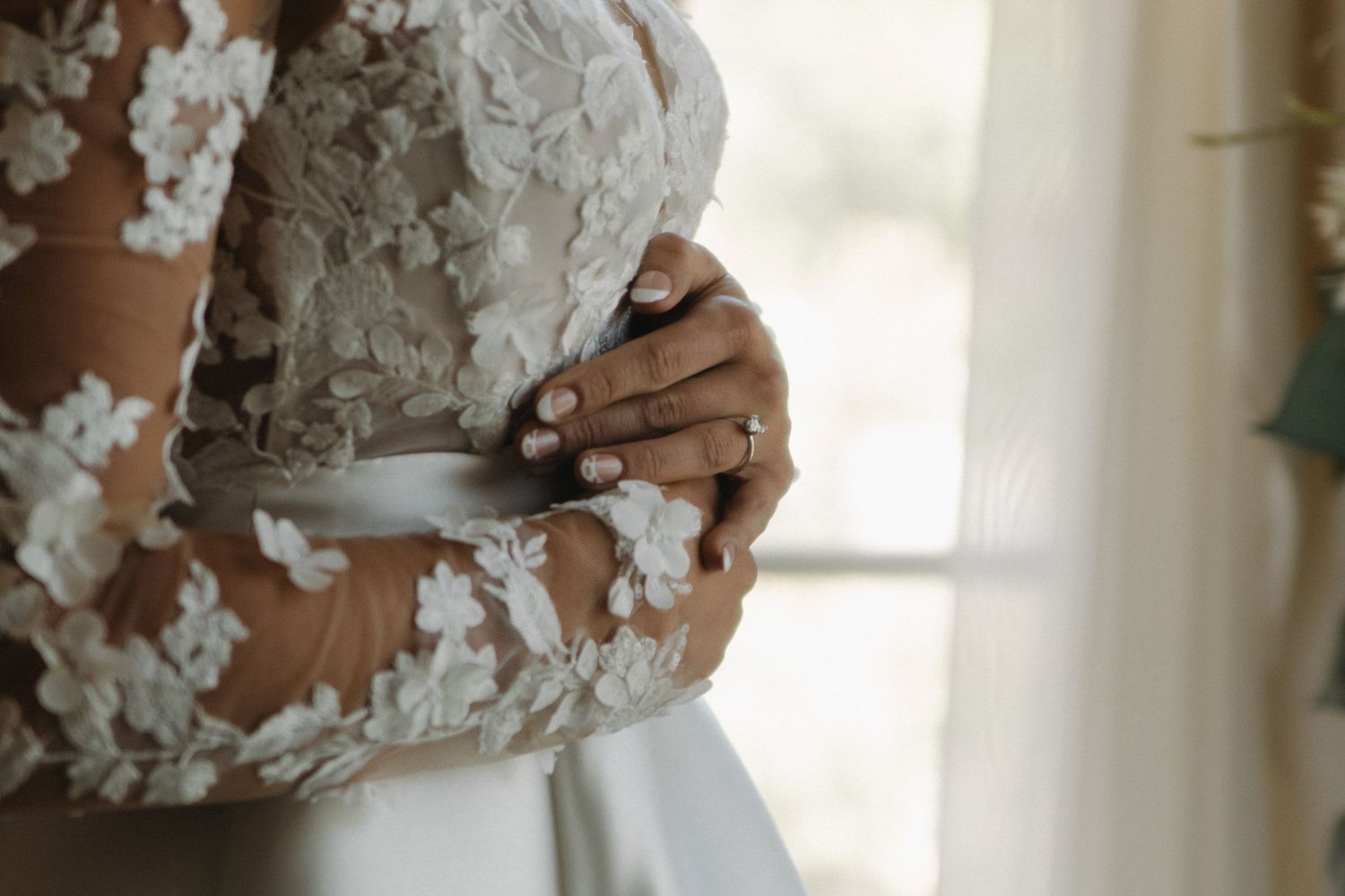 Close-up detail shots of intricate white lace wedding dress fabric.