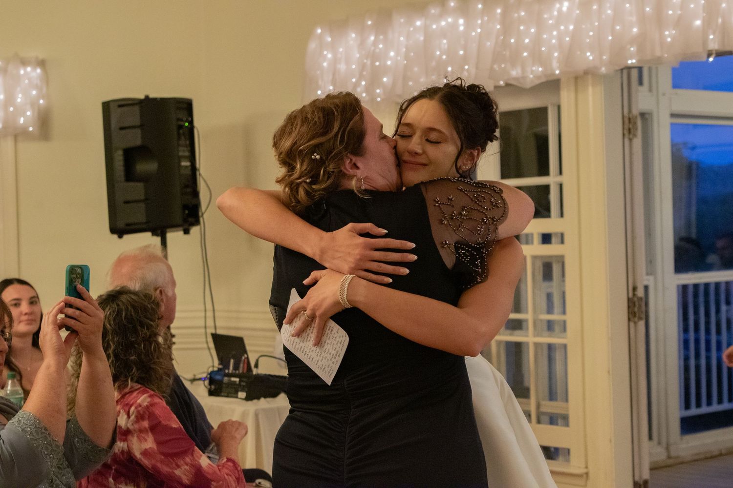 Wedding reception dance photos with string lights creating a romantic atmosphere.