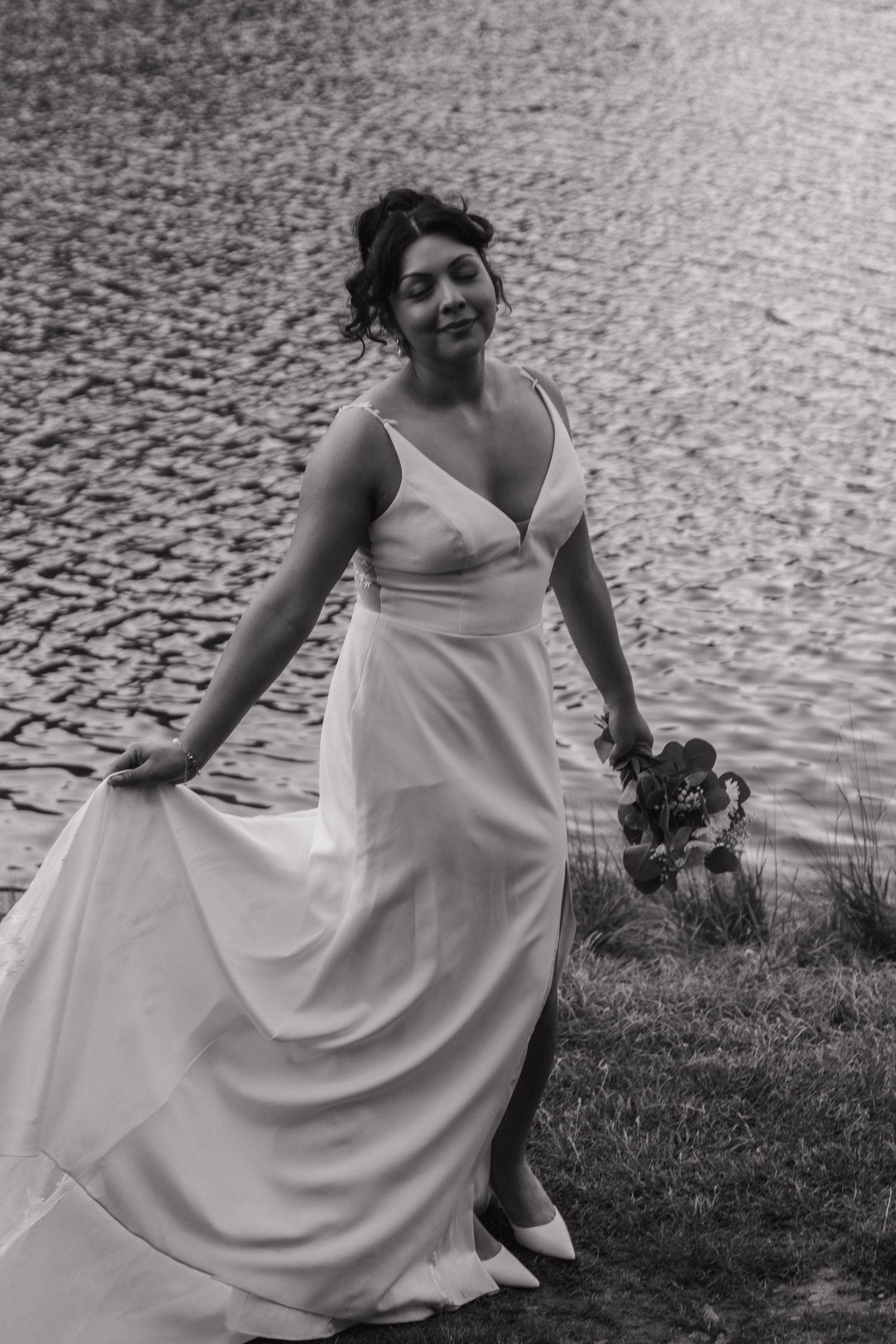 A flowing white wedding dress moves gracefully in a series of artistic shots near cobblestones and grass.