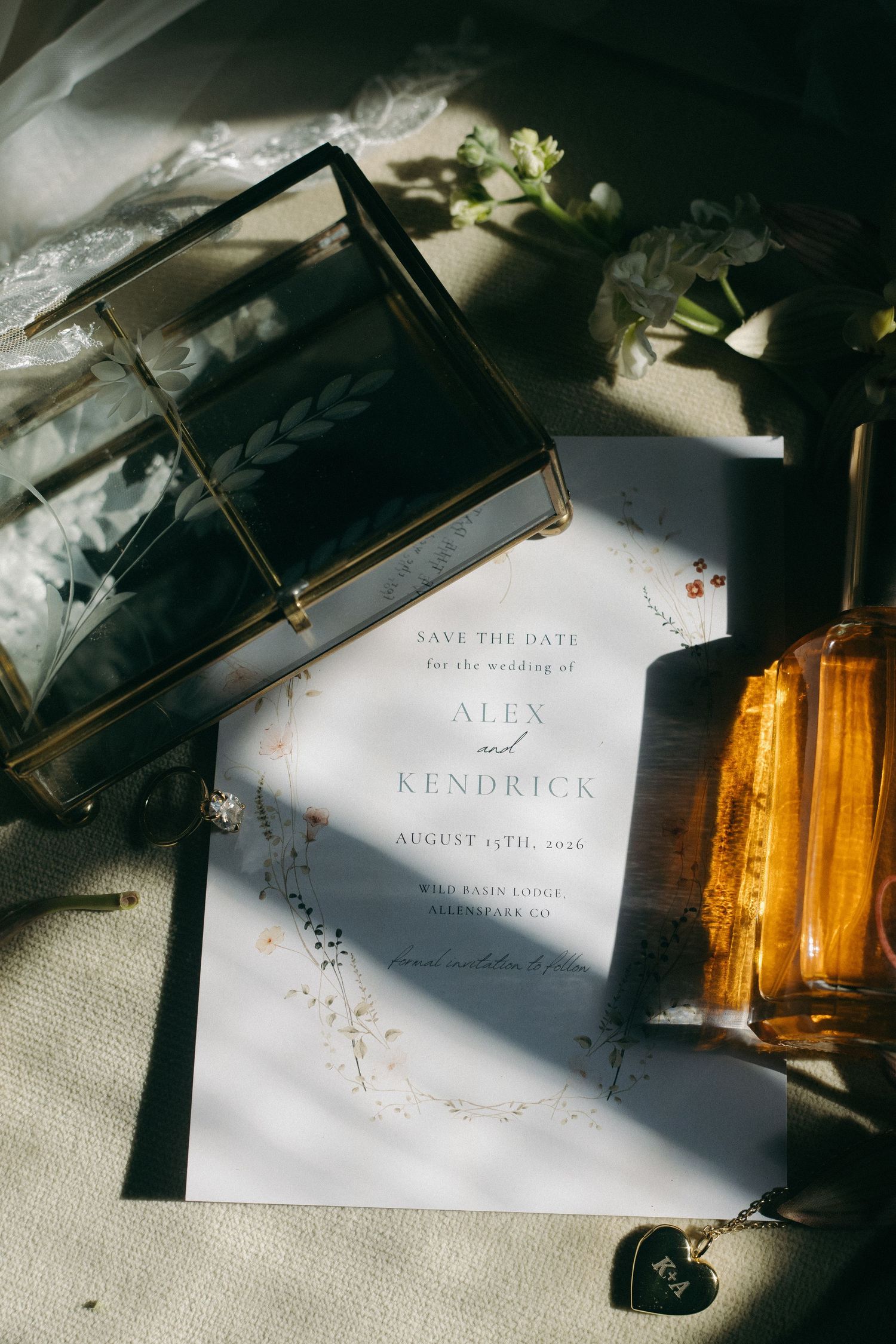 Wedding invitation cards with elegant typography and floral designs in dramatic lighting.