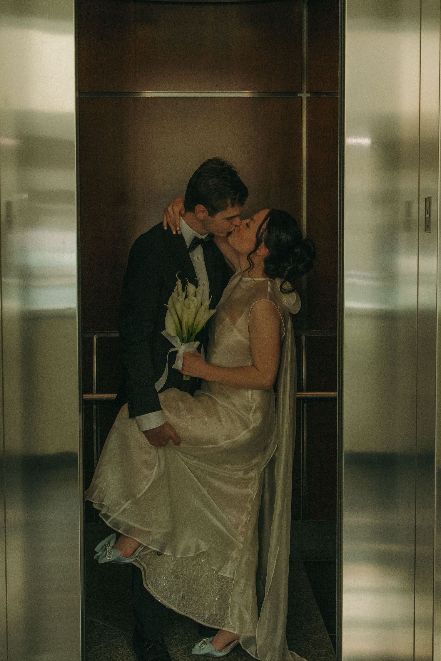 Romantic wedding couple sharing intimate moments in an elevator series.