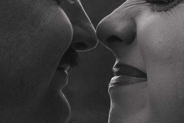 Black and white close-up of romantic moment between couple.
