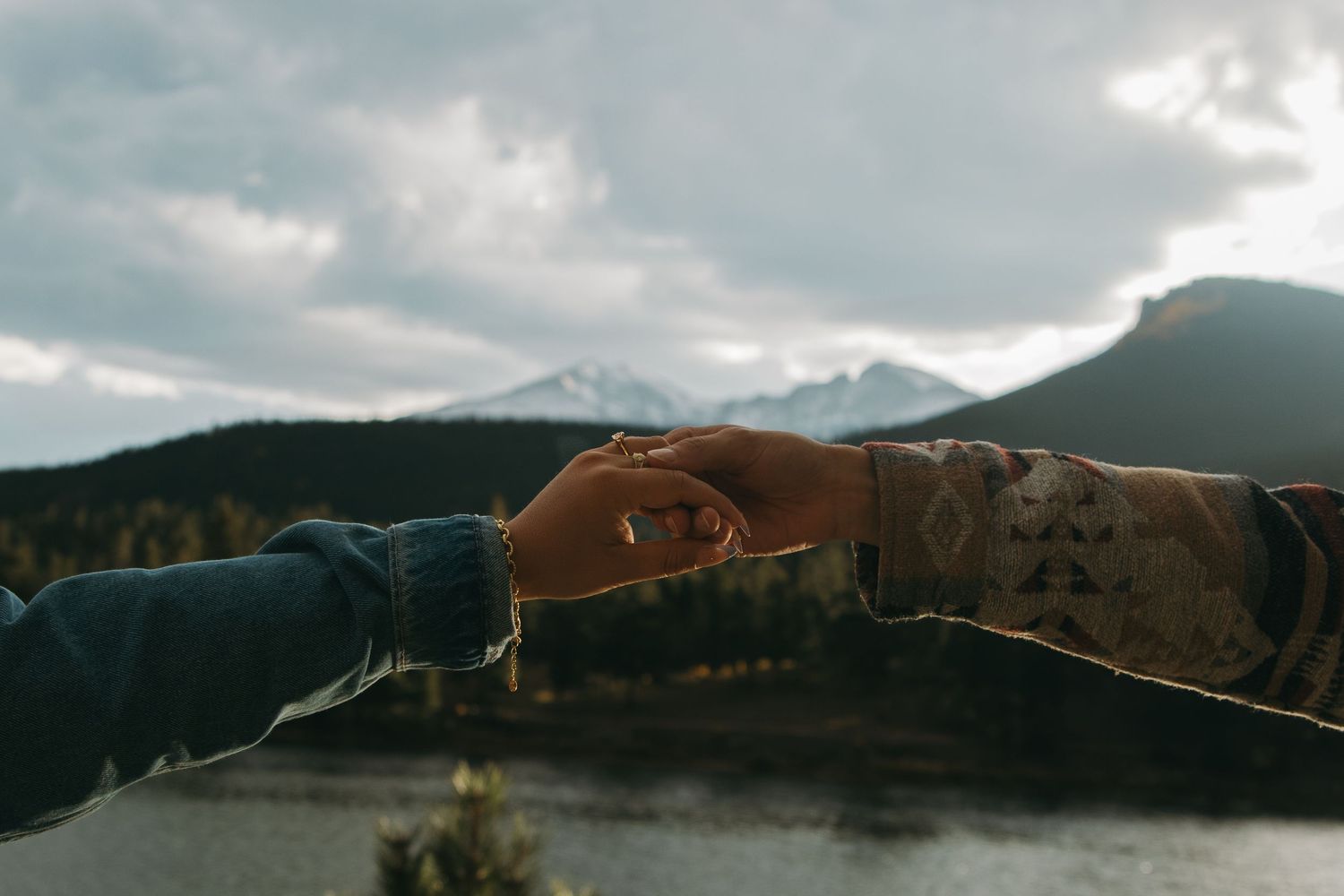 A panoramic view of mountains and cloudy skies stretches across multiple connected landscape photos.