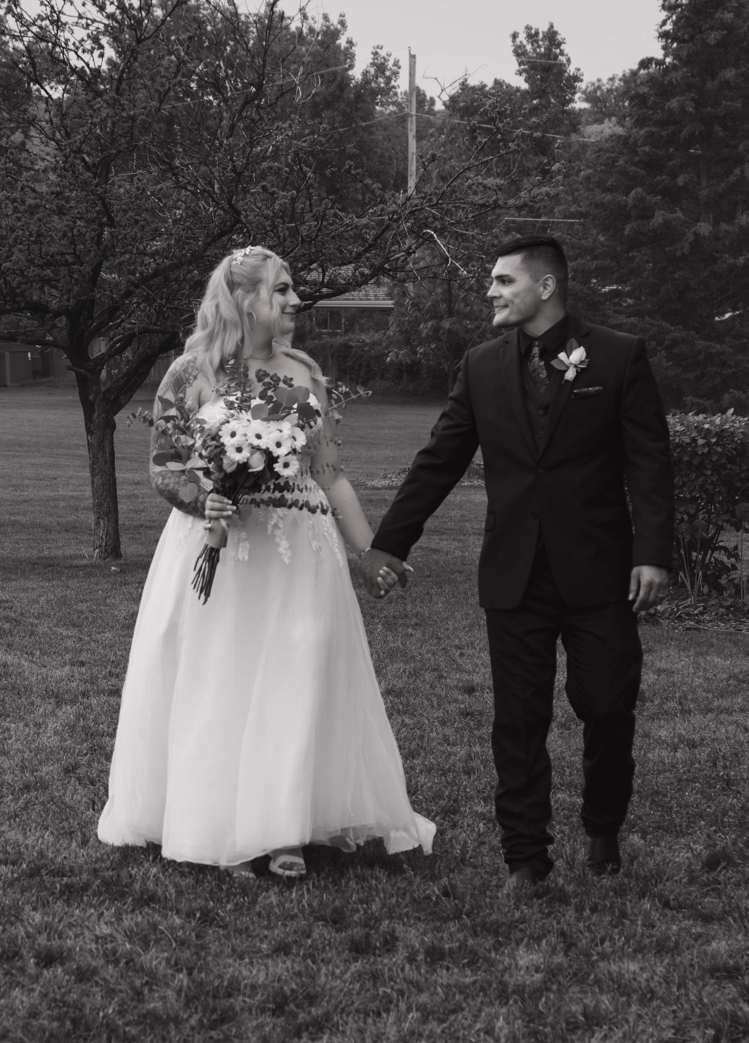 Black and white wedding photos showing tender moments between wedding party members.