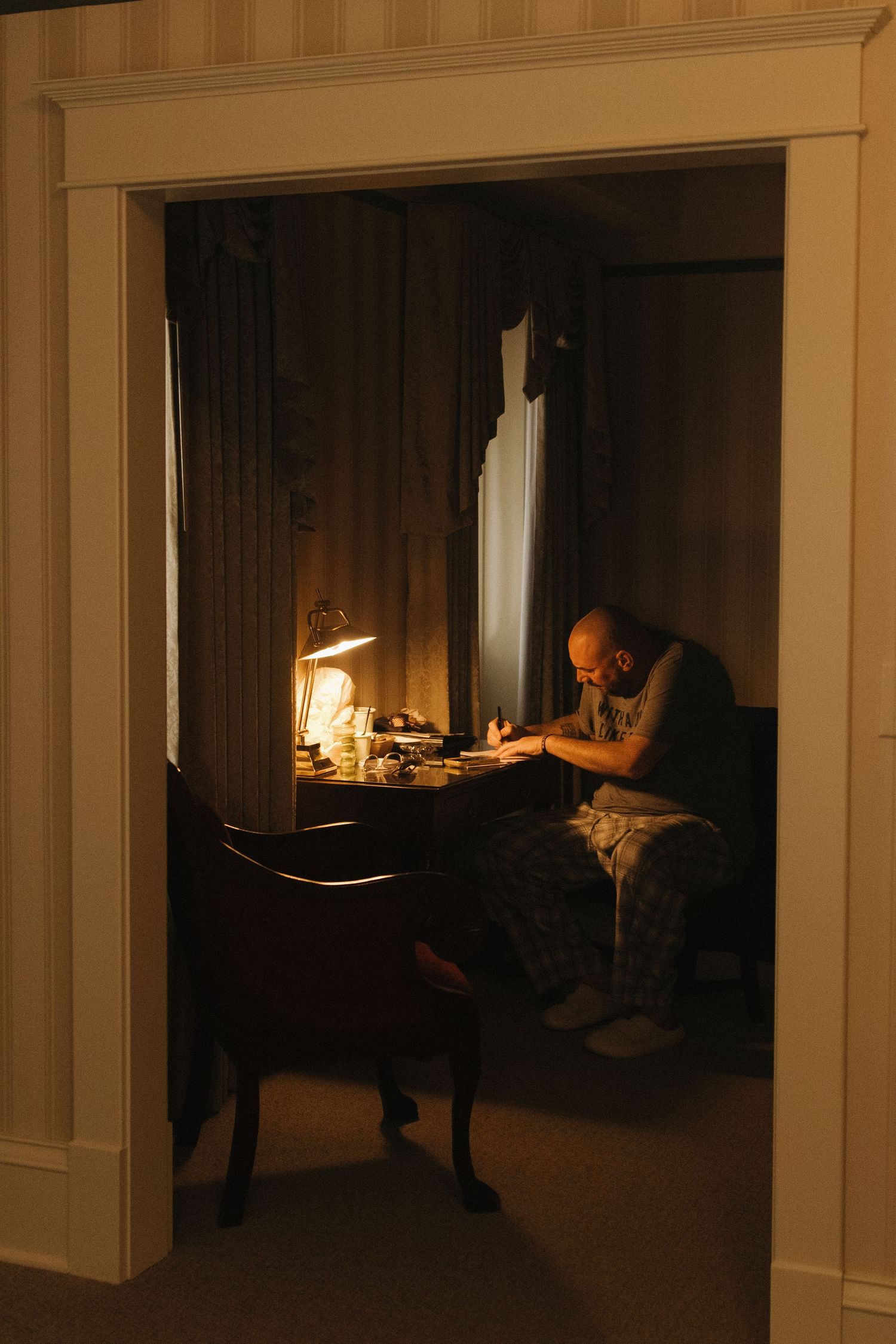A sequence of dark interior shots showing a dimly lit hallway with warm lighting creating moody atmosphere.