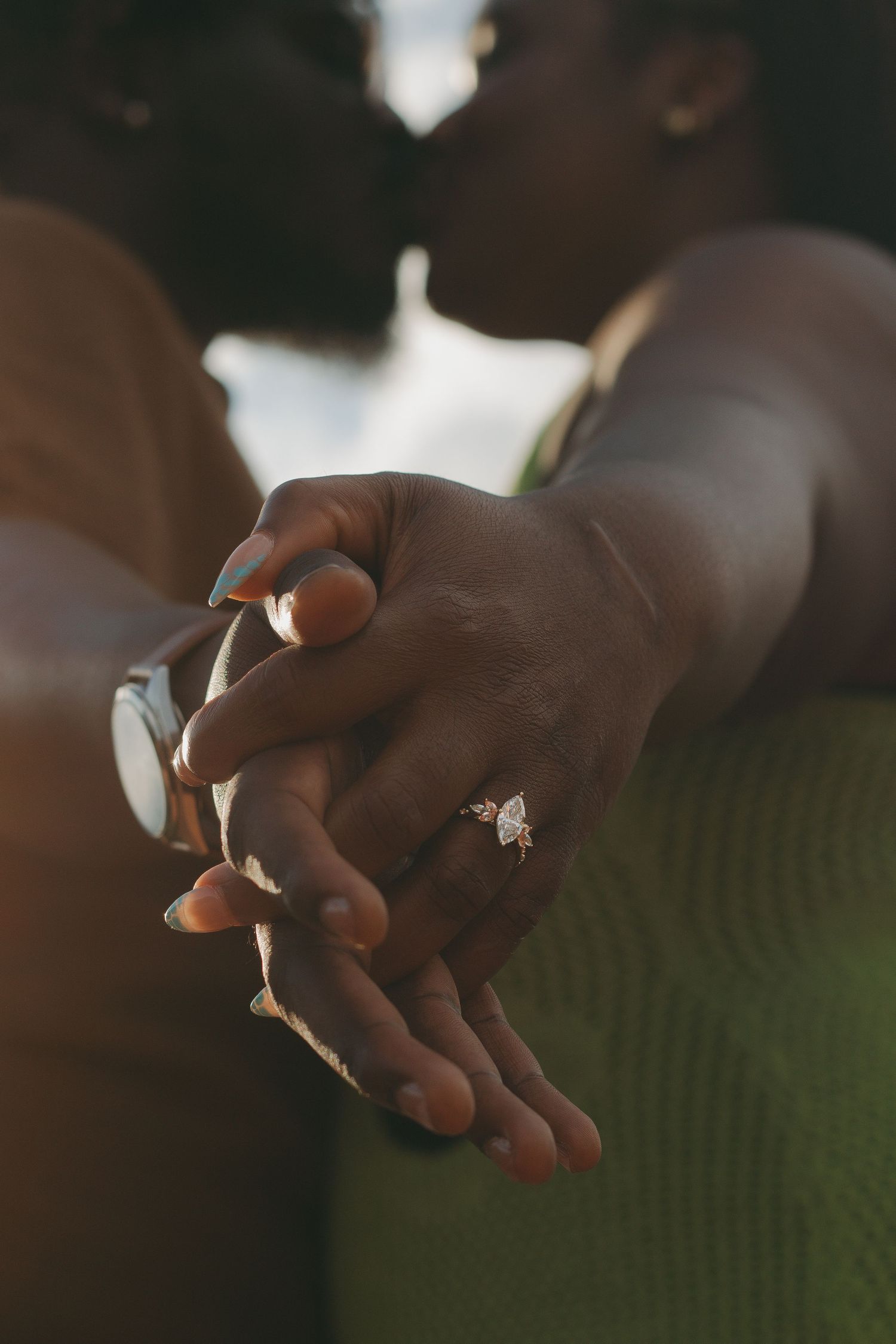 Close-up shot of hands delicately holding a small butterfly in soft natural lighting.