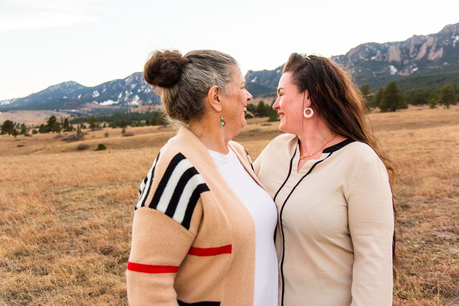 Natural lifestyle photo of mom and adult daughter reminiscing together, authentic family photography in Boulder area by Cassandra Jene