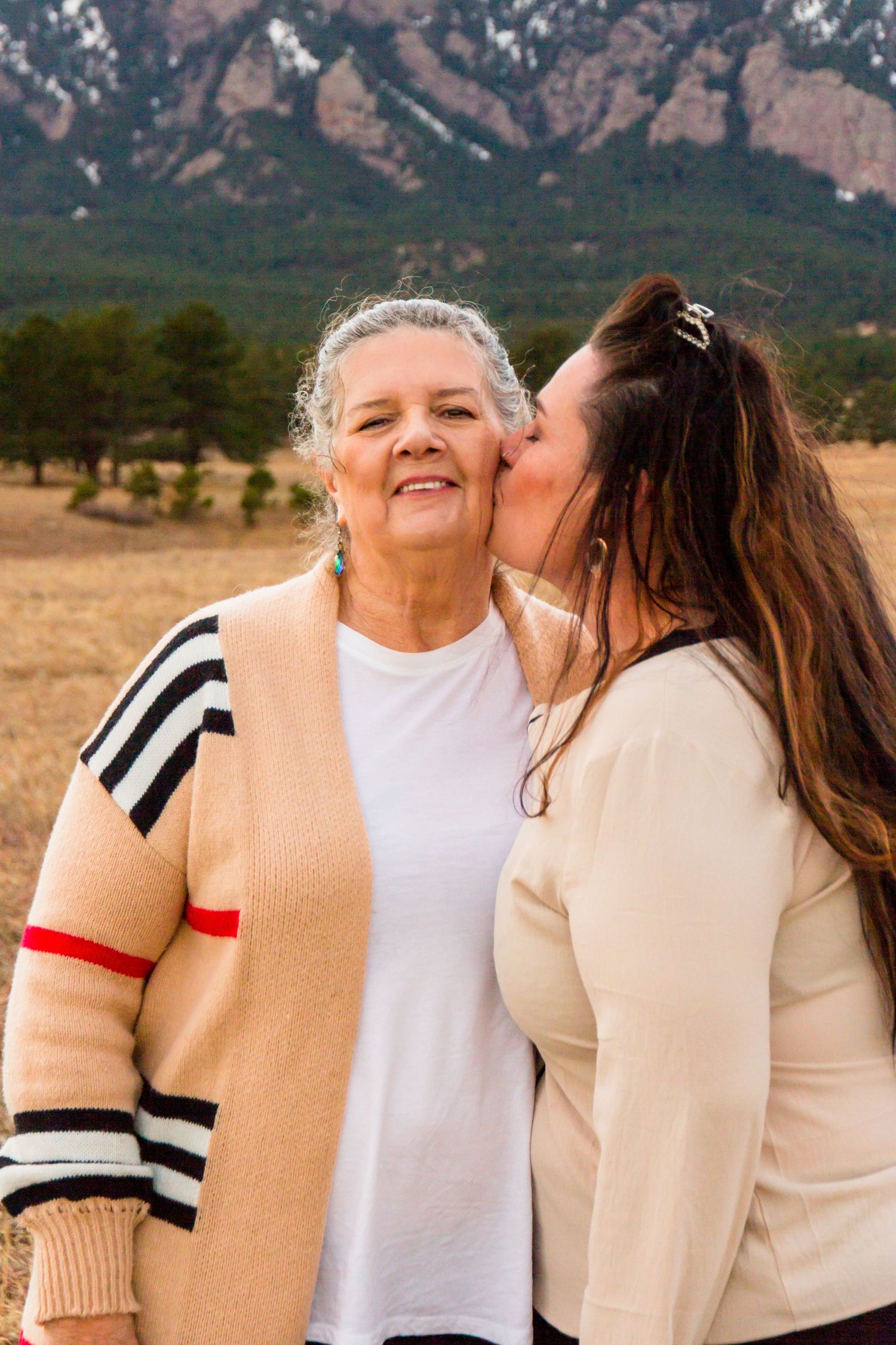 Emotional portrait of mother and adult daughter sharing a heartfelt moment, captured in Broomfield Colorado by Cassandra Jene Photography