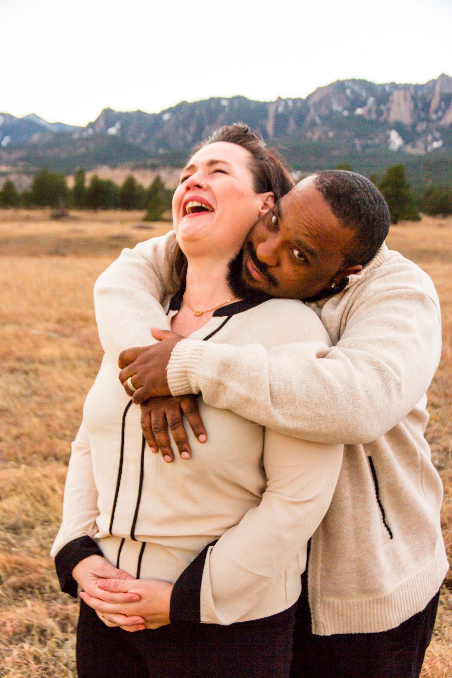 Joyful couple hugging and laughing in Boulder Colorado, candid lifestyle photography by Cassandra Jene