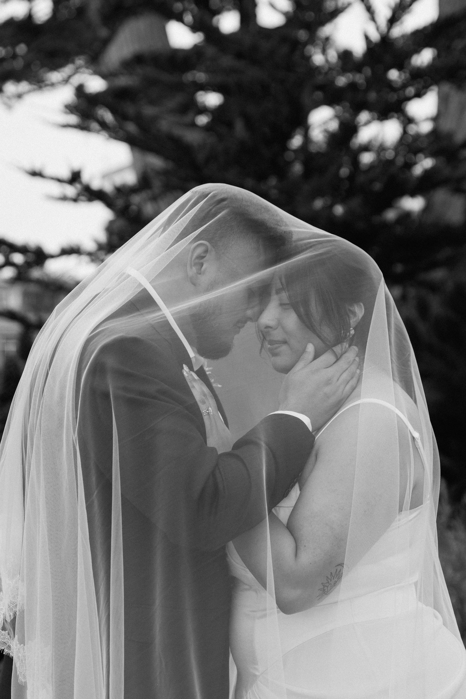 Black and white wedding photo sequence showing tender moments under a delicate veil.